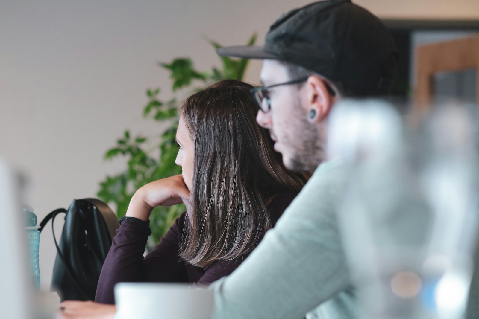 Support engineer helping a colleague at a workstation