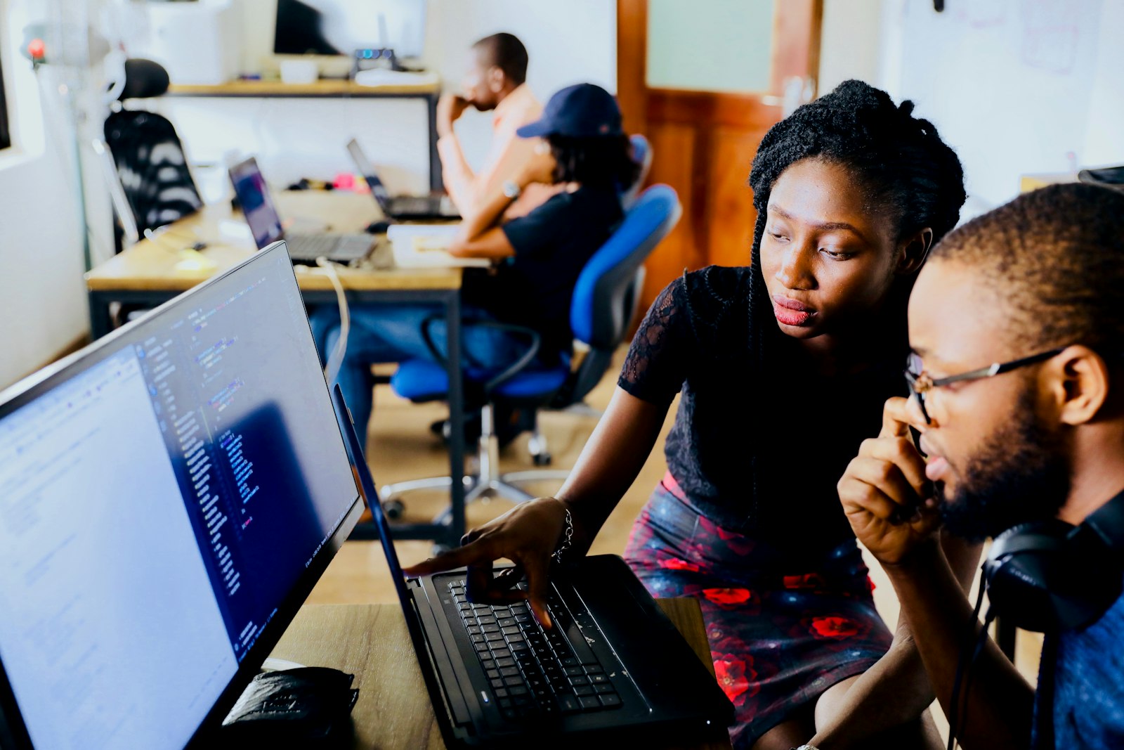 Software engineers reviewing code together